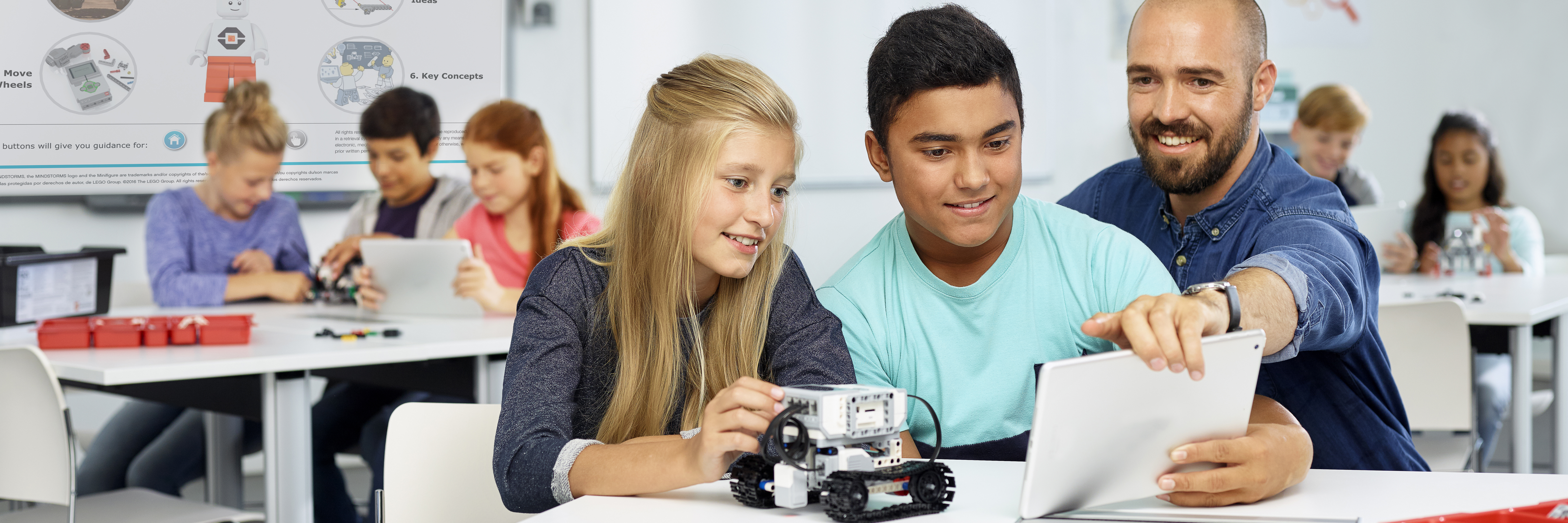 Middle school students and technolgy teacher tinker with The MINDSTORMS EV3 from LEGO Education.