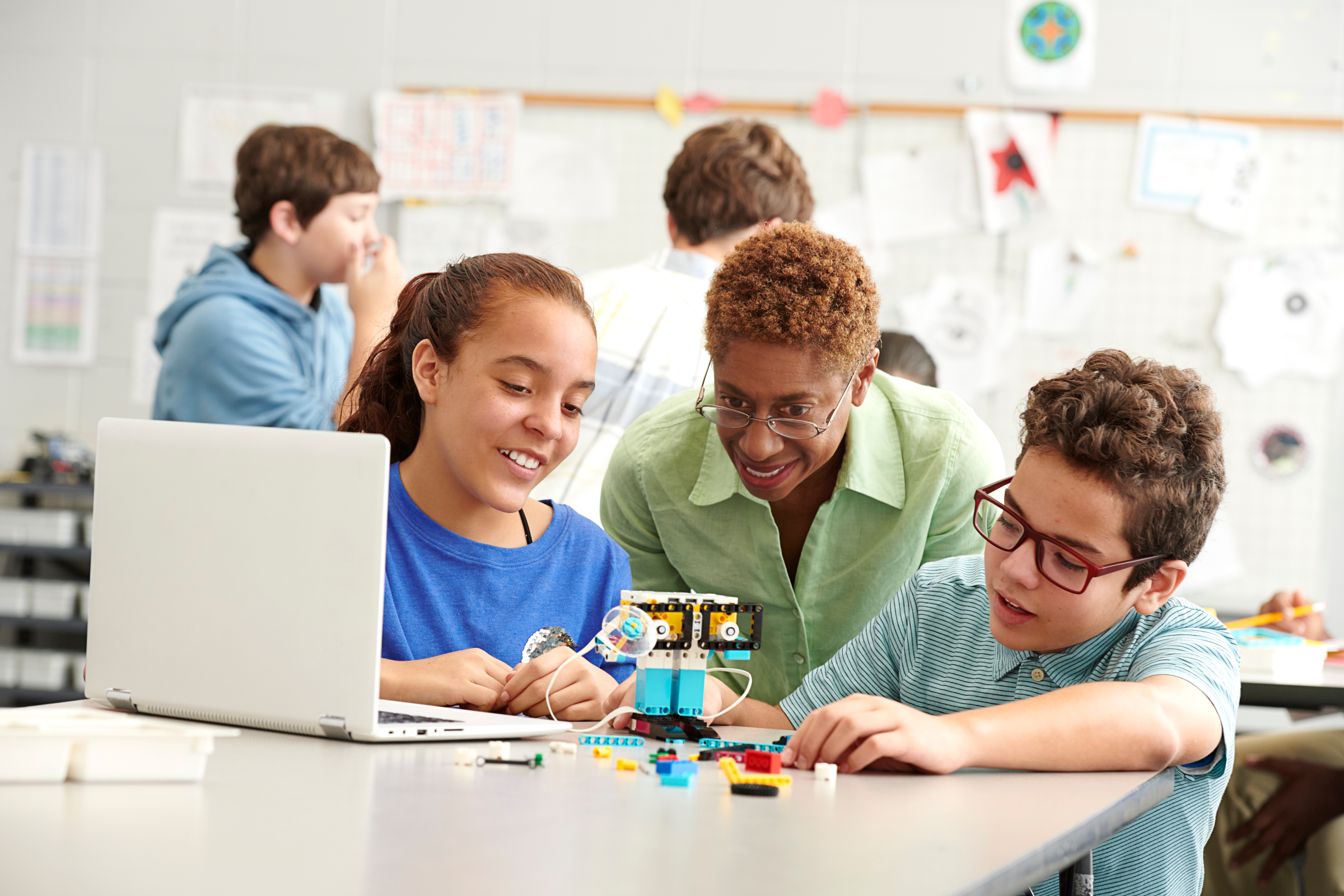 Two secondary school students and a teacher learning problem-solving and critical thinking with LEGO Education SPIKE Prime.