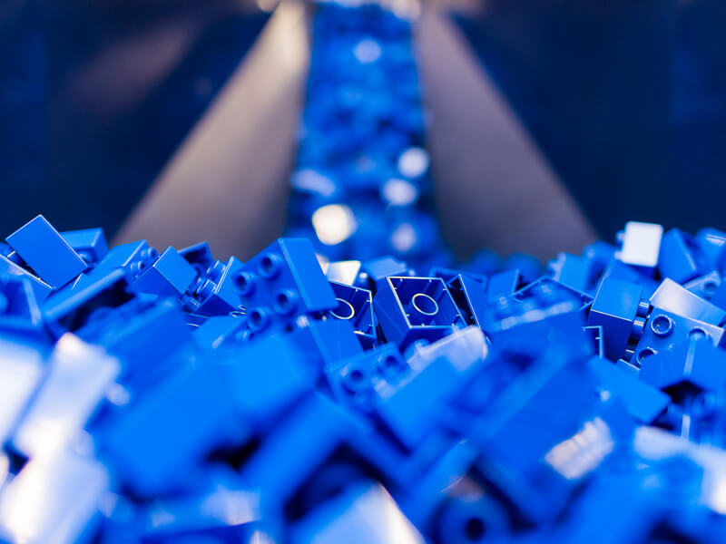 Blue LEGO bricks on a production line